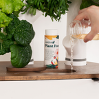 Adding Gardyn Plant Food liquid nutrients to water tank for healthy plant growth